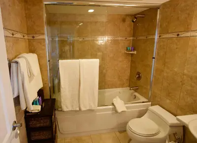 a bathroom with a tub and a toilet and a shower at Century Plaza Hotel in Vancouver