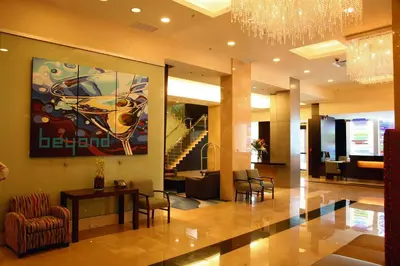 a lobby with a table and chairs and a painting at Century Plaza Hotel in Vancouver