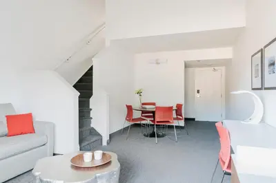 a living room with a couch and a table at Elk + Avenue Hotel in Banff