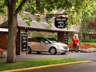 a car parked in front of a store with a sign at Royal Scot Hotel & Suites in Victoria