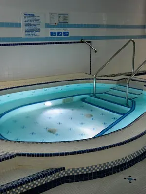 a large hot tub in a swimming pool at Royal Scot Hotel & Suites in Victoria