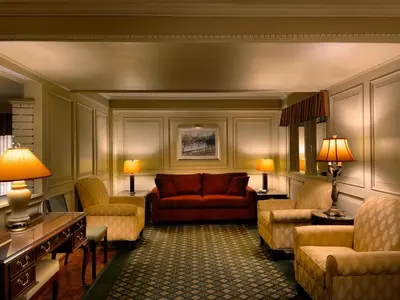 a living room with a red couch and chairs at Royal Scot Hotel & Suites in Victoria