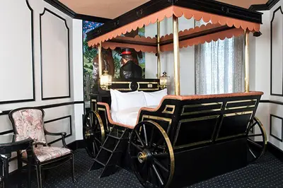 a room with a carriage with a man in the mirror at Fantasyland Hotel in Edmonton