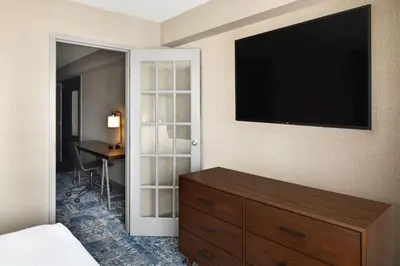 a bedroom with a dresser and a flat screen tv at Four Points by Sheraton Edmonton South in Edmonton
