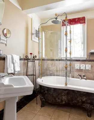 a bathroom with a tub and a sink at Abigail's Hotel in Victoria