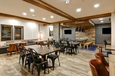 a restaurant with tables and chairs in a room at Canalta Lodge in Banff
