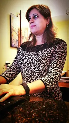 a woman sitting at a desk with her hands on a keyboard at James Bay Inn Hotel, Suites & Cottage in Victoria
