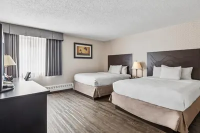 a hotel room with two beds and a desk at Radisson Hotel & Conference Centre Edmonton in Edmonton