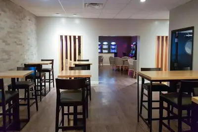 a dining room with wooden tables and chairs at Radisson Hotel & Conference Centre Edmonton in Edmonton