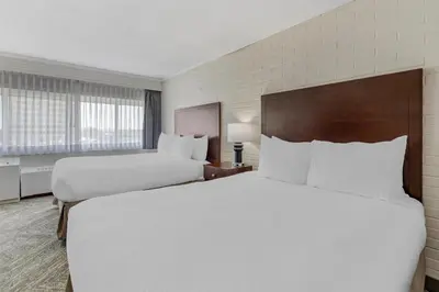a hotel room with two beds and a window at Best Western Cedar Park Inn in Edmonton