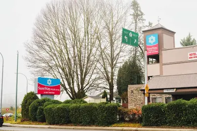 a street sign in front of a building at SureStay Plus by Best Western Coquitlam in Coquitlam