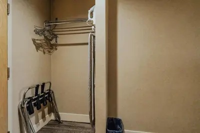 a room with a closet with a door open at SureStay Plus by Best Western Coquitlam in Coquitlam