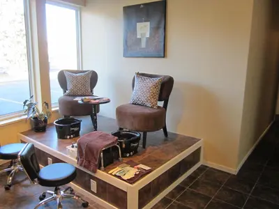 a salon with two chairs and a table and a mirror at Super 8 by Wyndham West Kelowna BC in West Kelowna