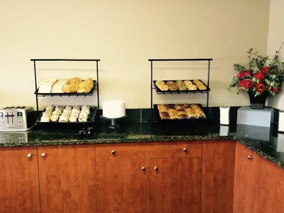 two racks of pastries sitting on a counter in a kitchen at Super 8 by Wyndham West Kelowna BC in West Kelowna