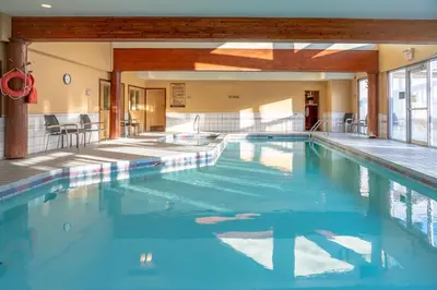a large swimming pool with blue water at Banff Rocky Mountain Resort in Banff
