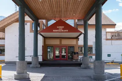 a building with a red door in front of it at Banff Rocky Mountain Resort in Banff