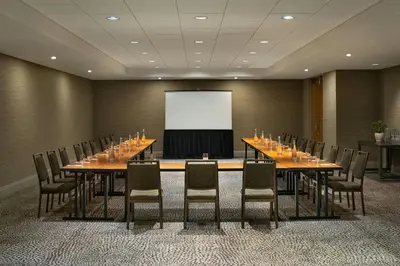 a conference room with tables and chairs and a screen at The Westin Edmonton in Edmonton