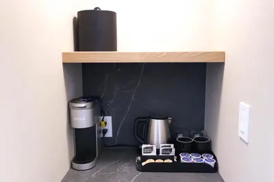 a coffeemaker and a coffee maker on a shelf at Forest Park Hotel in Jasper