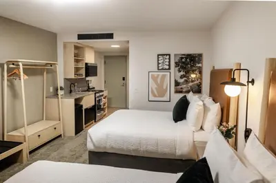 a hotel room with a bed and a kitchen at Forest Park Hotel in Jasper