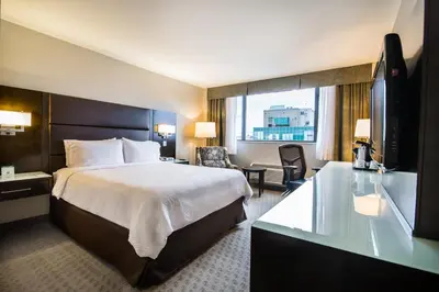 a hotel room with a bed and a television at Holiday Inn Vancouver-Centre Broadway by IHG in Vancouver
