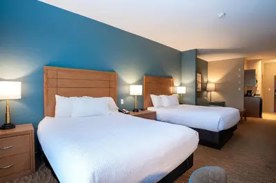 a hotel room with two beds and two lamps at Sandman Hotel and Suites Squamish in Squamish