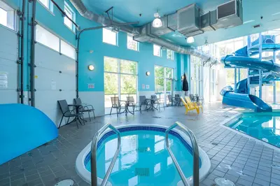 a large indoor swimming pool with a slide at Sandman Hotel and Suites Squamish in Squamish