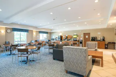 a restaurant with tables and chairs and a cafeteria at Sandman Hotel and Suites Squamish in Squamish
