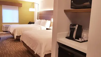 a hotel room with two beds and a window at Holiday Inn Express and Suites Surrey by IHG in Surrey