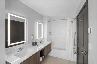 a white bathroom with a sink and a shower at Holiday Inn Hotel & Suites Surrey East - Cloverdale by IHG in Surrey