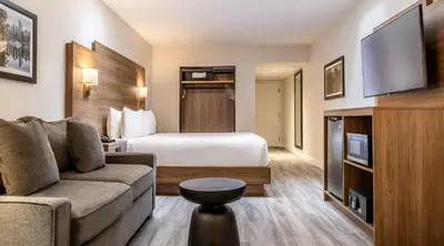 a hotel room with a bed and a couch at Atrium Hotel Vancouver in Vancouver