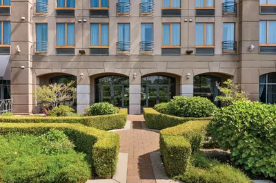 a building with hedges in front of a building at Holiday Inn & Suites North Vancouver by IHG in North Vancouver