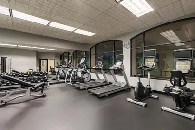 a gym with a row of treadmills and machines at Holiday Inn & Suites North Vancouver by IHG in North Vancouver