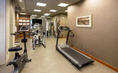 a gym with two tread machines and a treadmill at Holiday Inn Express Vancouver-Metrotown (Burnaby) in Burnaby