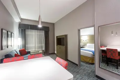 a hotel room with a bed and a mirror at Holiday Inn Express & Suites Riverport Richmond by IHG in Richmond