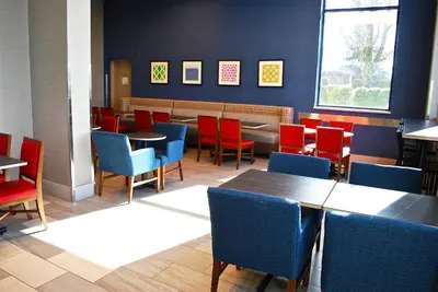 a dining room with tables and chairs in a restaurant at Holiday Inn Express Vancouver Airport-Richmond by IHG in Richmond