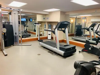 a gym with treadmills and ellipticals in a room at Holiday Inn Express and Suites Calgary by IHG in Calgary