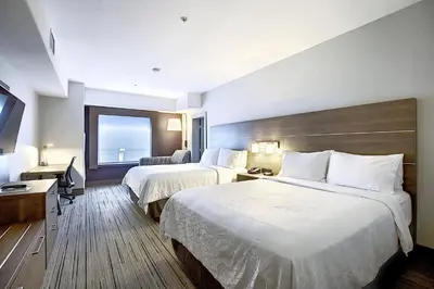 a hotel room with two beds and a window at Holiday Inn Express Airport Calgary by IHG in Calgary