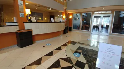 a lobby with a check in counter in a building at Holiday Inn Express Calgary South by IHG in Calgary