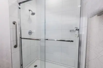 a bathroom with a shower with a glass door at Holiday Inn Express Calgary South by IHG in Calgary