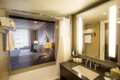 a bathroom with a sink and a large mirror at Pinnacle Hotel at the Pier in North Vancouver