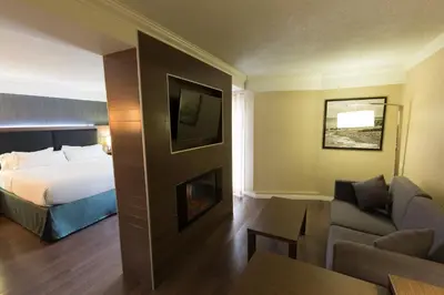 a hotel room with a bed and a couch at Holiday Inn Express Edmonton Downtown by IHG in Edmonton