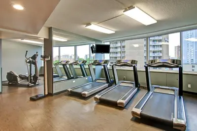 a gym with several treadmills in a building at Chateau Lacombe Hotel in Edmonton