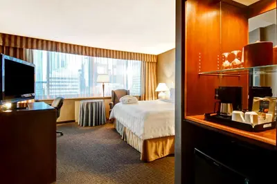 a hotel room with a bed and a large window at Chateau Lacombe Hotel in Edmonton