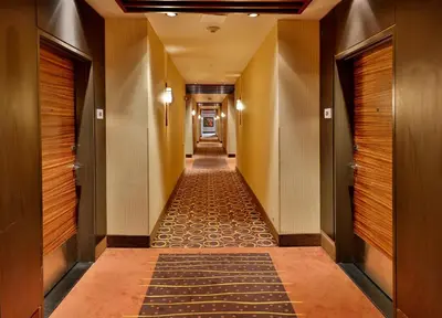 a hallway of a hotel with a long corridor at Edmonton Hotel & Convention Center Edmonton in Edmonton