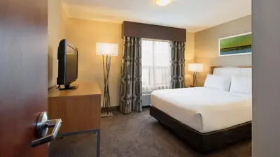 a hotel room with a bed and a television at Holiday Inn Express Hotel & Suites Sherwood Park-Edmonton Area by IHG in Sherwood Park