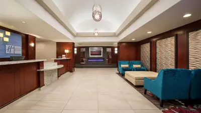 a lobby with blue chairs and a waiting room at Holiday Inn Express Hotel & Suites Sherwood Park-Edmonton Area by IHG in Sherwood Park