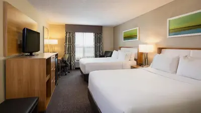 a hotel room with two beds and a flat screen tv at Holiday Inn Express Hotel & Suites Sherwood Park-Edmonton Area by IHG in Sherwood Park