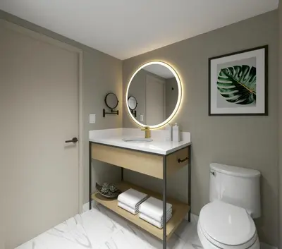 a bathroom with a sink and a mirror at Hotel Kelowna & Conference Centre in Kelowna