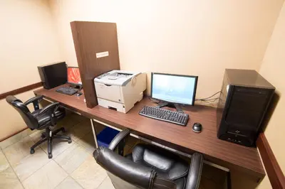 an office with a desk with a computer and a printer at Holiday Inn Hotel & Suites-West Edmonton by IHG in Edmonton