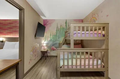 a childs bedroom with two bunk beds and a wall mural at Best Western Plus West Edmonton in Edmonton